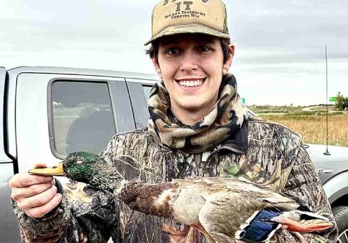  Young man holds up duck hunted on trip