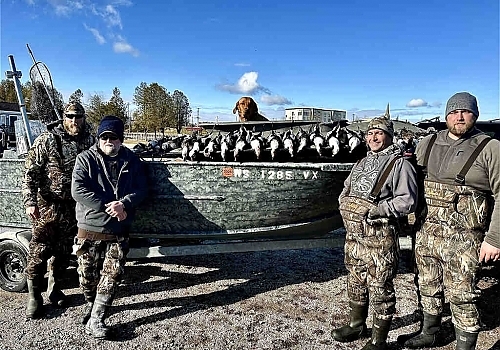Group poses with their ducks from Gray Goose trip