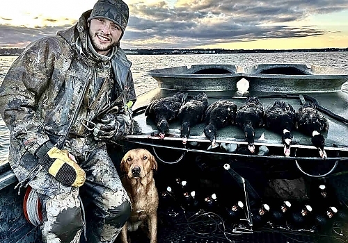  Man and dog show ducks hunted on Gray Goose trip