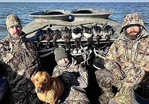  Close up view of hunters and dog on Gray Goose trip