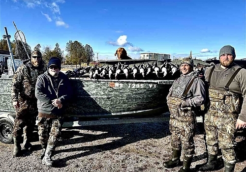  Group poses with ducks hunted on trip