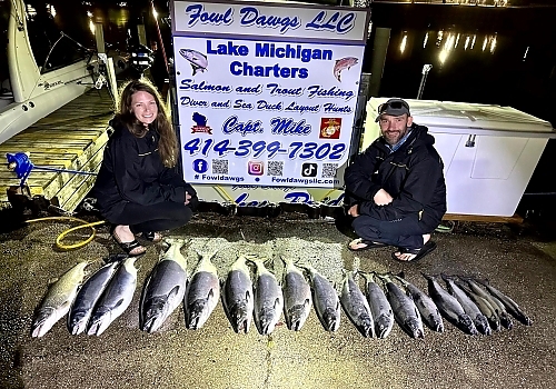 Group posing with fish caught at night