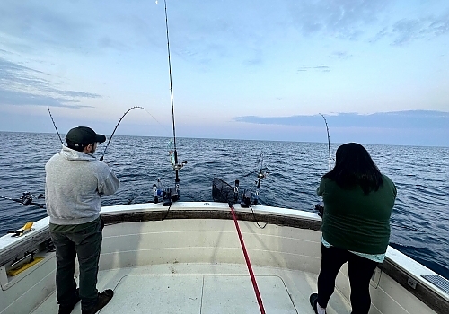 Couple fishing on boat.