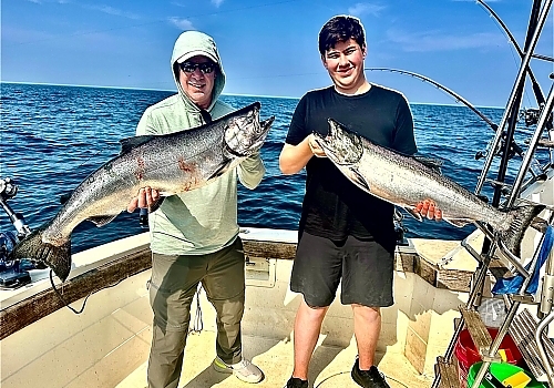 Two men hold up catch on deep fishing trip